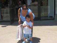 Hiding behind my son and my shopping bags in CA, Los America